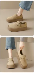 Close-up of khaki suede platform clogs featuring vintage metal buckles and non-slip soles