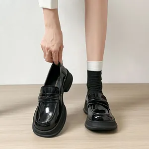 Classic black patent leather platform loafers with chunky soles and round toe design