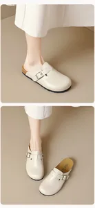 Detailed side view of beige platform clogs with cork sole and adjustable metal buckle