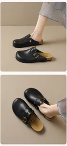 Close-up of black matte leather clogs with cork footbed and bronze metal buckle detail