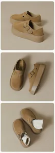 Detail view of brown suede platform loafer with retro metal buckle and thick sole