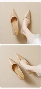 Detailed view of beige pointed-toe kitten heels with smooth leather finish and elegant fit
