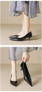 Macro shot of elegant black pointed toe kitten heels with glossy finish and slim heel