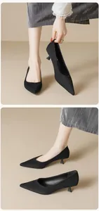 Detail of black suede pointed-toe kitten heels showing elegant matte finish and slim heels