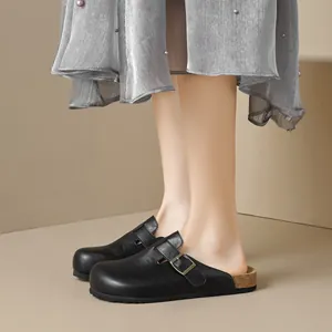 Women's black closed-toe Birkenstock-style clogs with platform cork sole and buckle strap