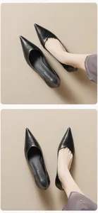 Detailed view of the soft leather texture and branded insole on black pointed toe pumps