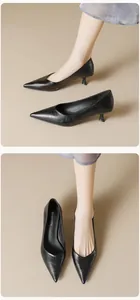 Detail of elegant black pointed-toe kitten heel pumps with soft matte leather texture