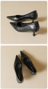 Detail view of black pointed toe kitten heels featuring polished leather and elegant silhouette