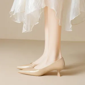 Elegant pointed-toe beige pumps with kitten heels and glossy finish for professional wear