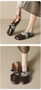 Detail view of retro brown flat mules with square toe and floral knot fabric decoration