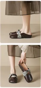 Macro detail of dark brown square-toe mule with floral fabric crisscross strap detail
