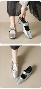 Macro shot of silver square toe Mary Jane shoes with shimmering rhinestone buckle detail