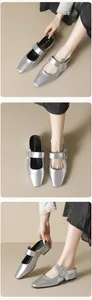 Detailed close-up of square rhinestone buckle and silver metallic texture on mule shoes