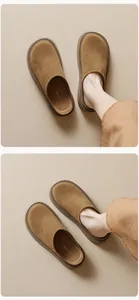 Detail of tan suede platform mule slippers showing soft matte texture and thick sole design