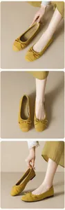 Detail view of ginger yellow suede ballet flats featuring a delicate bow tie on round toe