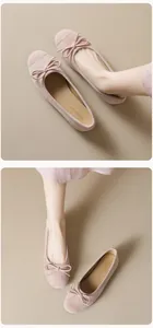 Detailed macro view of pink suede ballet flats featuring a delicate bow and round toe
