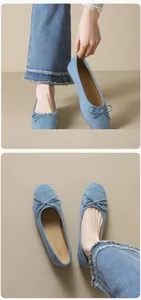 Detail of light blue suede ballet flats featuring a decorative bow and soft sole texture