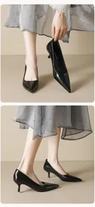 Close-up detail of black pointed toe stilettos showing sleek glossy finish and high heel