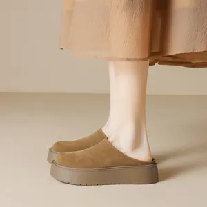Brown suede platform mule shoes with thick soles for women in a minimalist indoor setting
