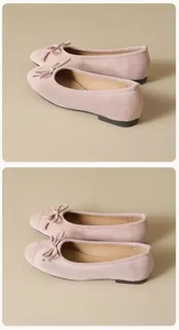 Close-up of pink suede ballet flats with bow detail and soft rubber soles for women