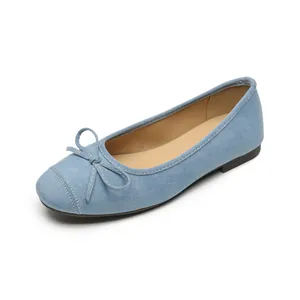 Light blue suede ballet flats with bow detail and soft sole from a top-down view