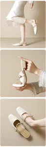 Detail view of cream pointed toe mules with metal rivet straps and flexible leather sole