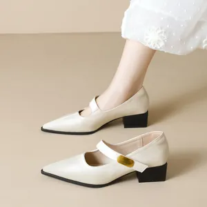 Cream pointed Mary Jane pumps with black block heels and decorative gold fashion buckle