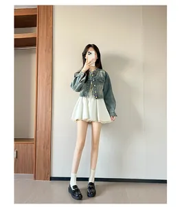 Full body mirror selfie of a woman wearing retro blue denim jacket and platform loafers