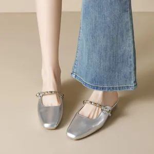 Silver metallic square toe mule with gold studded strap and backless block heel