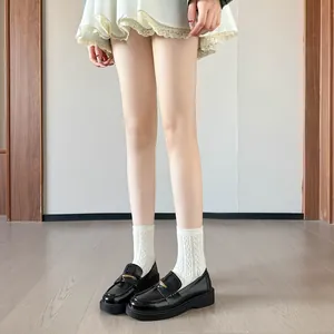 Classic black patent leather loafers with gold metal buckle and chunky platform sole