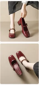 Close-up of wine red patent leather Mary Jane shoes with square toe and block heel
