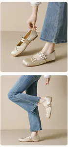 Detailed close-up of champagne satin Mary Jane flats featuring dual straps and bow design
