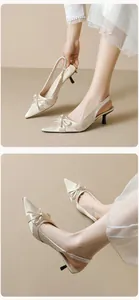 Detail of silk pointed-toe slingback pumps featuring a bow accent and elegant kitten heel