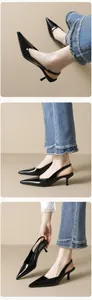 Detail of black pointed toe kitten heel slingbacks with glossy patent leather finish