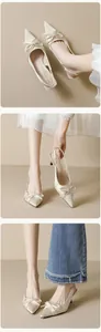 Detailed shot of pointed toe kitten heel sandals with satin bow and slingback strap