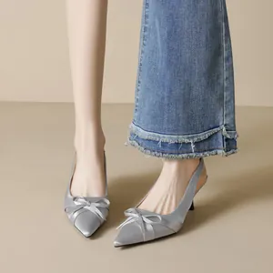 Elegant silver pointed toe slingback heels with satin bow detail and slim stiletto heels