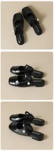 Detail of black patent leather mule with pearl buckle and elegant pointed toe design
