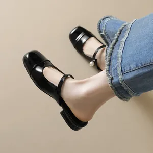 Elegant black patent leather mule with pearl strap and square toe in French style
