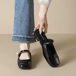 Elegant black patent leather Mary Jane mules with oversized pearl accent on the strap