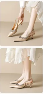 Macro shot of nude pointed-toe stiletto pumps with luxury rhinestone chain detailing