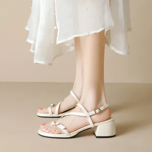 Elegant beige ankle strap chunky heel sandals for women with stylish pearl dress
