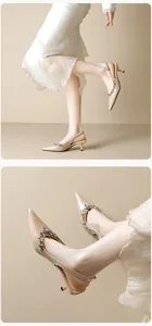 Detail of elegant pointed toe slingback heels with sparkling rhinestone arch decoration