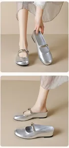 Detail of silver metallic Mary Jane mule with elegant wrinkled texture and round toe