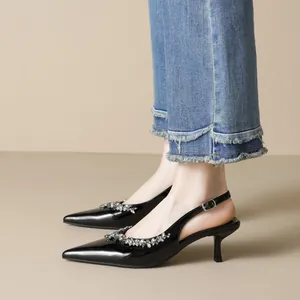 Elegant black patent leather pointed toe heels with rhinestone decor and kitten heel design