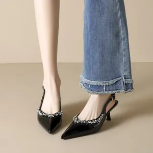 Elegant black patent leather slingback heels with rhinestone trim and slim mid heels