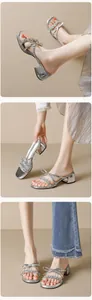 Close-up of silver block heel sandals featuring sparkling rhinestones and a bow knot detail