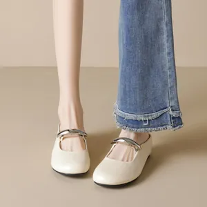 Chic cream round-toe Mary Jane flats featuring a sleek silver metal buckle accent
