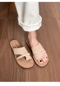 Top view of women's beige leather flip flops with visible hand-stitched sole detail