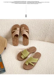 Detailed close-up of suede thong sandals with crisscross straps and toe loop design