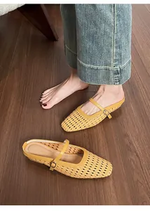Close-up of woven hollow texture and buckle strap on beige pointed toe mules